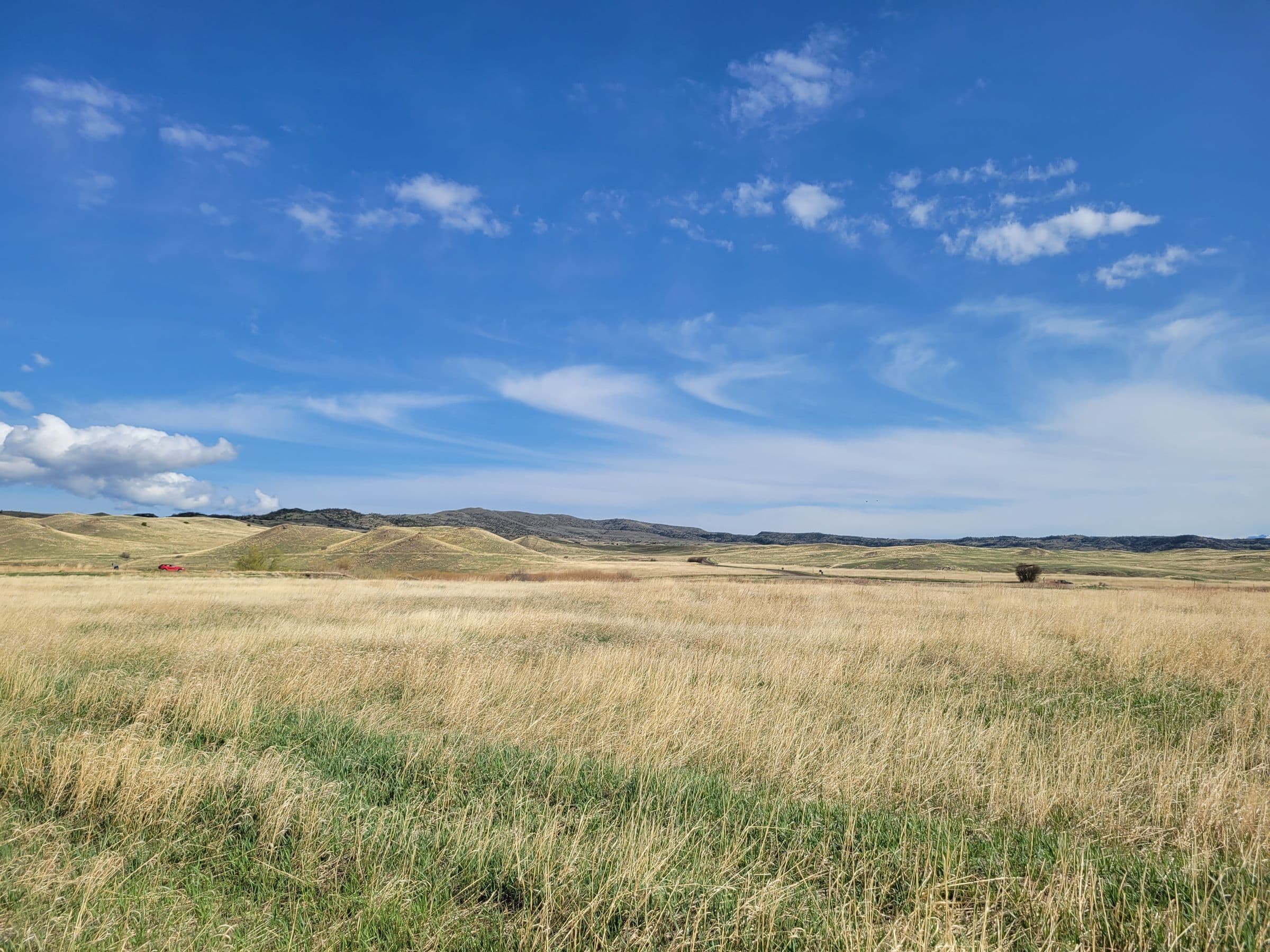 Open prairie grassland with distant hills, near our windshield replacement Rapid Valley SD service area